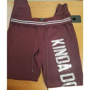 Rue21 Small Burgundy sweatpants with"Kinda Don't Care" in silver sequins down t